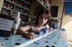 A woman sitting at a counter in a bar.