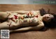 A naked woman laying on a wooden table covered in sushi.